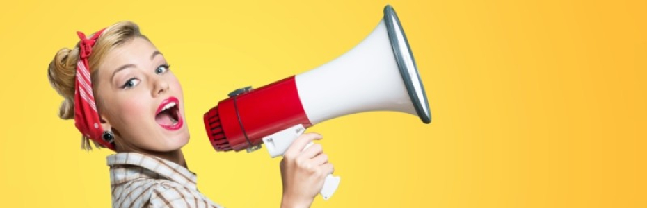 Portrait of woman holding megaphone, dressed in pin-up style