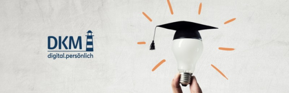 Hand of businessman holding glowing light bulb with graduation hat on it