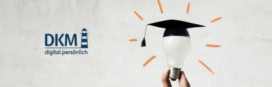 Hand of businessman holding glowing light bulb with graduation hat on it
